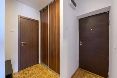 a hallway with two wooden doors and wooden floors at Marshal Nbg in Belgrade