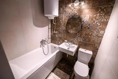 a bathroom with a toilet and a sink and a tub at Marshal Nbg in Belgrade