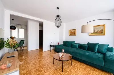 a living room with a green couch and a table at Marshal Nbg in Belgrade