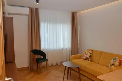 a living room with a couch and a chair at Unca in Belgrade