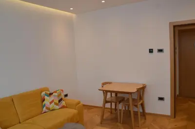 a living room with a couch and a table at Unca in Belgrade