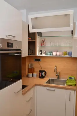 a kitchen with white cabinets and a sink at Unca in Belgrade
