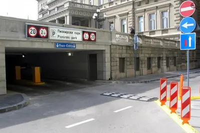 a tunnel in a city with a building and signs at Unca in Belgrade