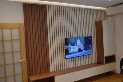 a flat screen tv on a wall in a room at Unca in Belgrade