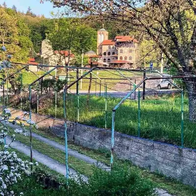 a fence with stairs in front of a house at Kosmajski raj in Nemenikuće