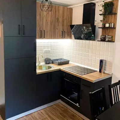 a kitchen with black cabinets and a sink at Kosmajski raj in Nemenikuće