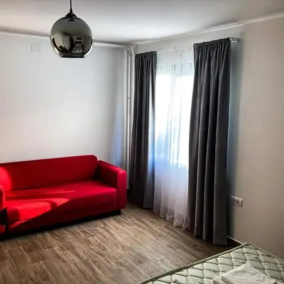a red couch in a living room with a window at Kosmajski raj in Nemenikuće
