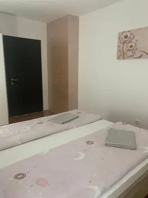 a bed with two laptops on it in a room at Lana in Arandjelovac