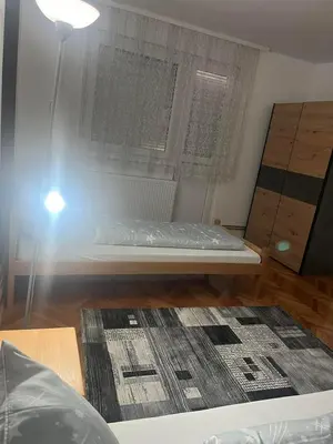 a small bedroom with a bed and a window at Lana in Arandjelovac