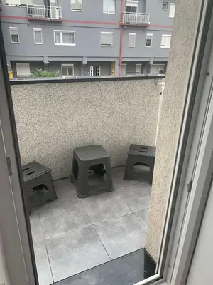 a view of a balcony with two benches and a building at Lana in Arandjelovac
