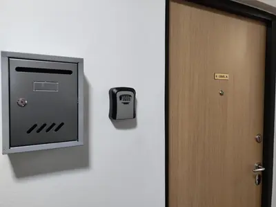a door with a clock on the wall and a safe at Banjica 2 in Voždovac
