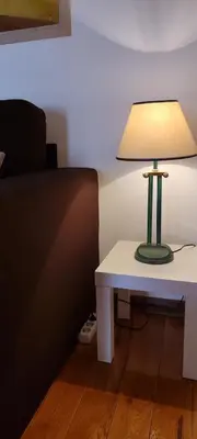 a lamp sitting on a table next to a bed at Luka 1718 Apartments in Belgrade