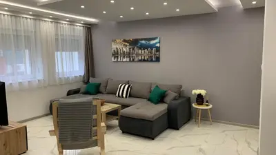a living room with a couch and a table at Jevtic in Vračar (historical)