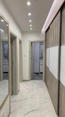 a corridor of an office with glass doors and tile floors at Jevtic in Vračar (historical)