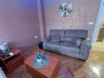 a living room with a couch and a table at Cuca Apartments in Belgrade