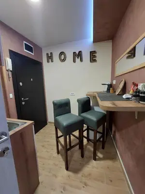 a home kitchen with two chairs and a table at Cuca Apartments in Belgrade