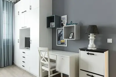 a bedroom with a desk with a chair and a cabinet at Indigo Apartment in Belgrade