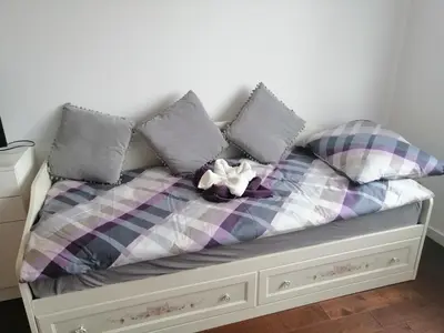 a bed with pillows and a stuffed animal on it at Anejo A Blok in Novi Beograd