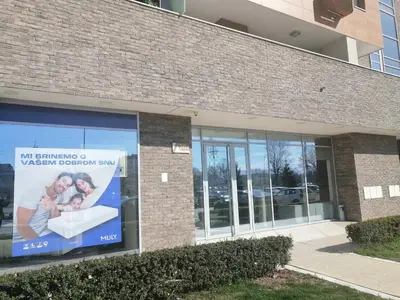 a building with a sign for a maternity hospital at Anejo A Blok in Novi Beograd