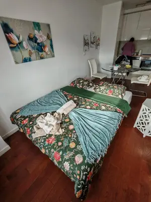 a bed with a blanket on it in a room at Anejo A Blok in Novi Beograd