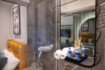 a bathroom with a shower with a mirror at Pedestrian street Center of Belgrade - mini rooms with paid PARKING in Belgrade