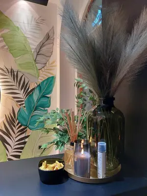 a vase with plants and candles on a table at Pedestrian street Center of Belgrade - mini rooms with paid PARKING in Belgrade