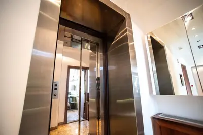 a hallway with a mirror and a elevator at Pedestrian street Center of Belgrade - mini rooms with paid PARKING in Belgrade