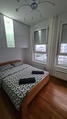 a bedroom with a bed with two pillows on it at Belville Delta City apartment, free parking in Belgrade