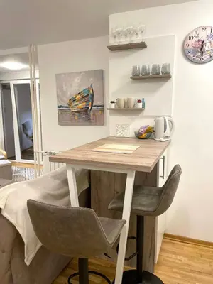 a kitchen with a wooden table and two chairs at Alma Vracar in Belgrade