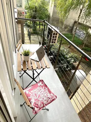 a balcony with a table and a laptop on it at Alma Vracar in Belgrade