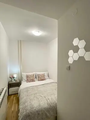 a bedroom with a bed in a white room at Alma Vracar in Belgrade