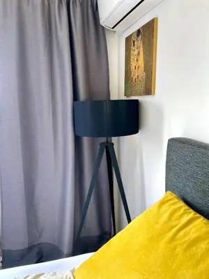 a bedroom with a blue lamp next to a bed at Vip Lounge 63 in Belgrade