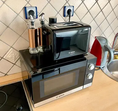 a toaster oven sitting on top of a counter at Vip Lounge 63 in Belgrade