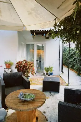 a patio with a table and chairs and a patio umbrella at Apartment Smokva in Belgrade