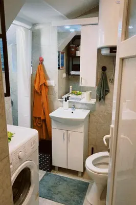 a small bathroom with a sink and a toilet at Apartment Smokva in Belgrade
