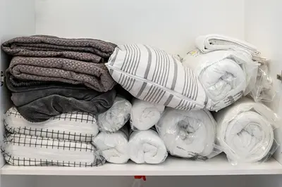 a pile of towels and blankets on a shelf at Deer Lux apartment Novi Dorcol-free parking in Belgrade