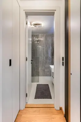 a bathroom with a walk in shower and a sink at Deer Lux apartment Novi Dorcol-free parking in Belgrade