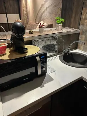 a microwave sitting on a kitchen counter next to a sink at Starry Sky in Belgrade