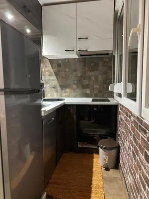 a kitchen with a stainless steel refrigerator and a brick wall at Starry Sky in Belgrade