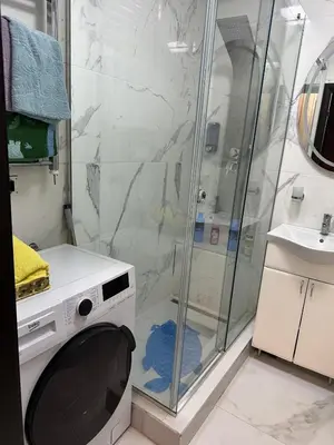 a washing machine in a bathroom with a shower at Starry Sky in Belgrade