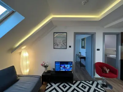 a living room with a couch and a red chair at MAIN SQUARE Apartment in Belgrade