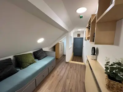 a living room with a blue couch in a room at MAIN SQUARE Apartment in Belgrade