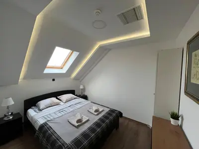 a bedroom with a bed with two towels on it at MAIN SQUARE Apartment in Belgrade