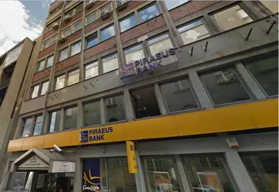 a building with a bank sign on the side of it at MAIN SQUARE Apartment in Belgrade