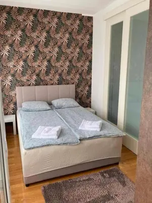 a bedroom with a bed with two towels on it at Apartment Belville, Suncokret 34 in Novi Beograd