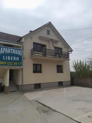 a house with a sign in front of it at LIBERO APARTMANI in Surčin