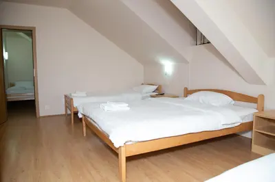 a bedroom with two beds and a staircase at Motel Imperija in Ub