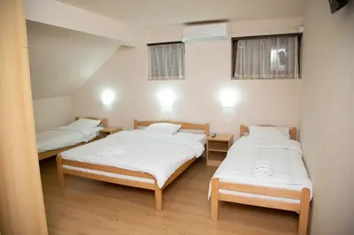 a room with two beds and two windows at Motel Imperija in Ub