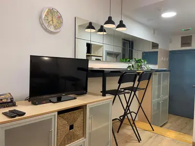 a living room with a desk with a flat screen tv at CITY CENTER Apartment in Belgrade