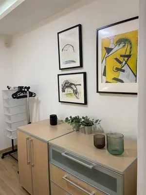 a desk in a room with paintings on the wall at CITY CENTER Apartment in Belgrade